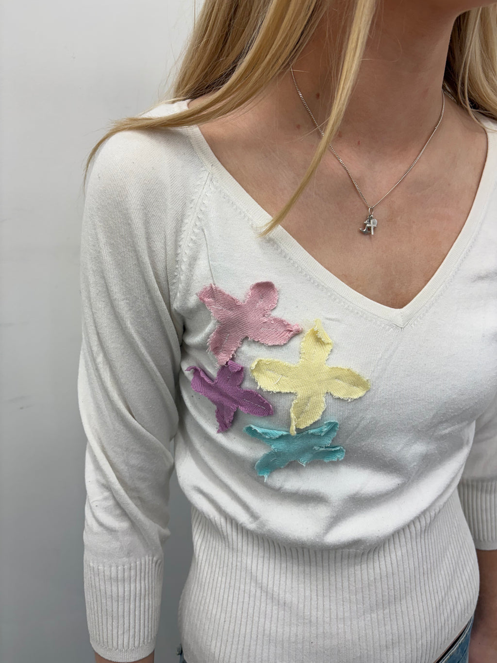 White V-Neck Sweater with Pastel Appliqué Details